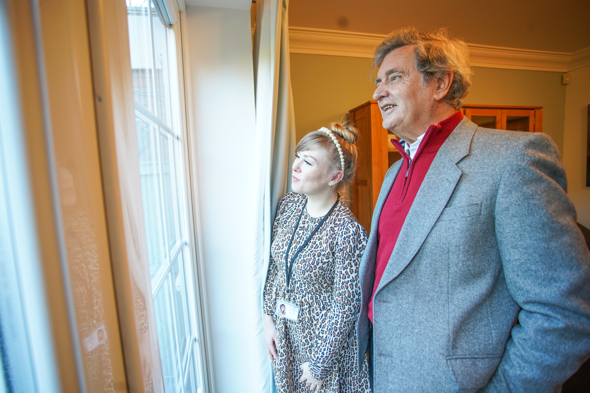 Right at Home Client and CareGiver looking out of window 