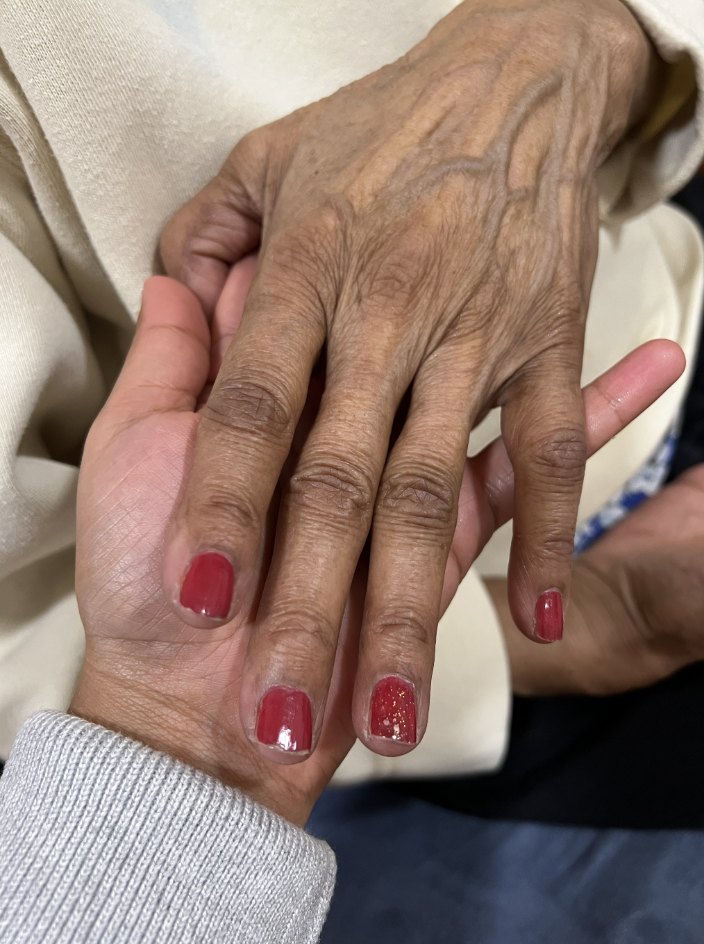 Granddaughter Holding Her Elderly Grandmothers Hand