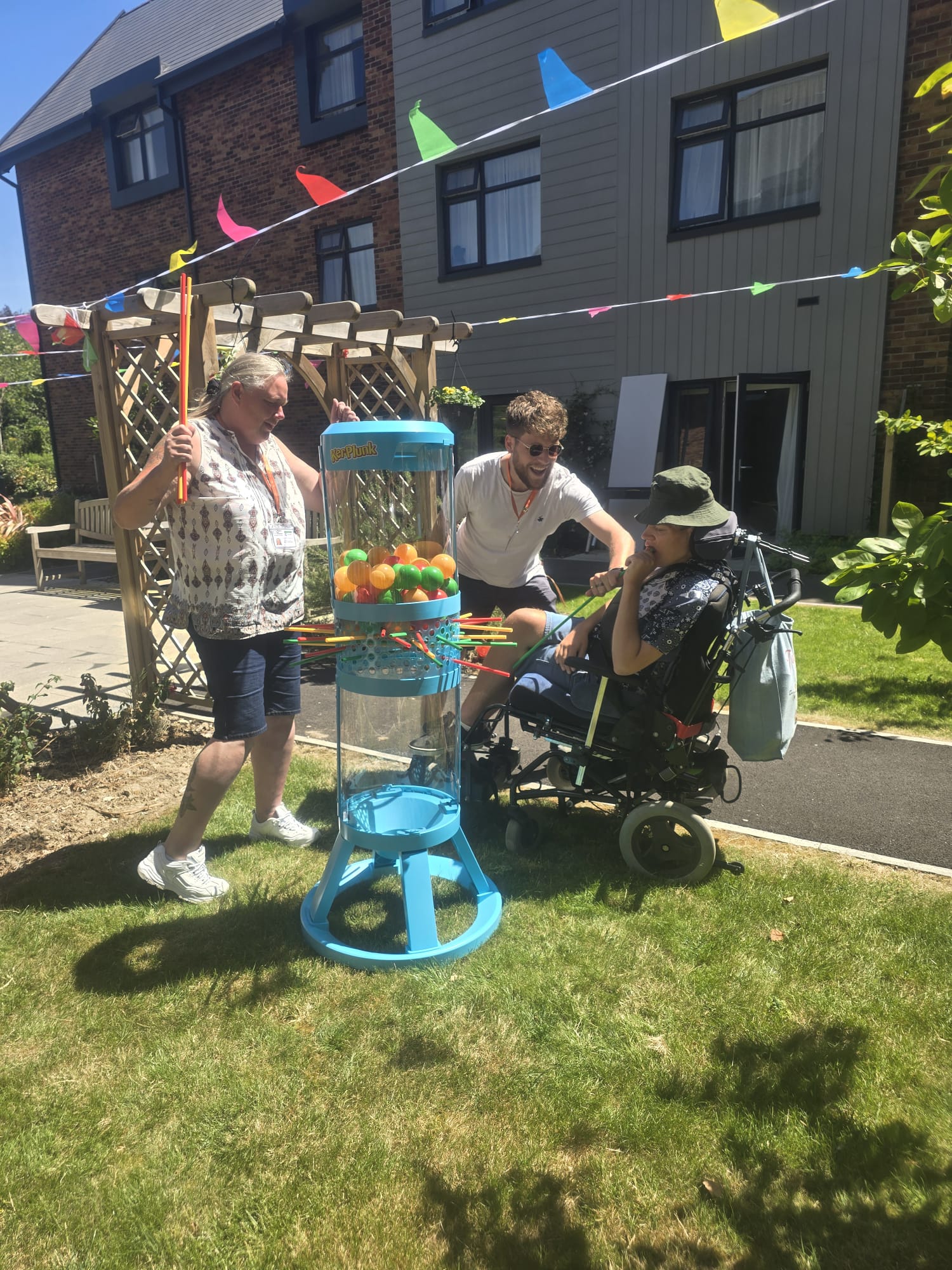 Ashley playing the giant KerPlunk game with his Care Assistant at the Big Green Picnic in Southampton.