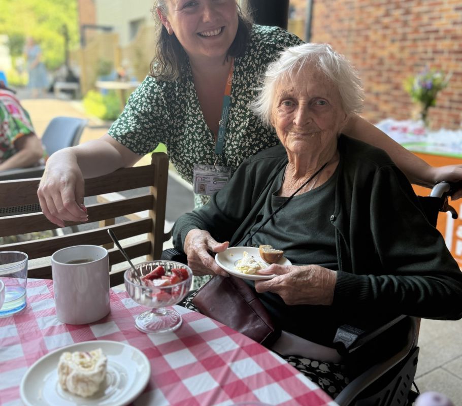 Caregiver with client during Big Green Picnic event.