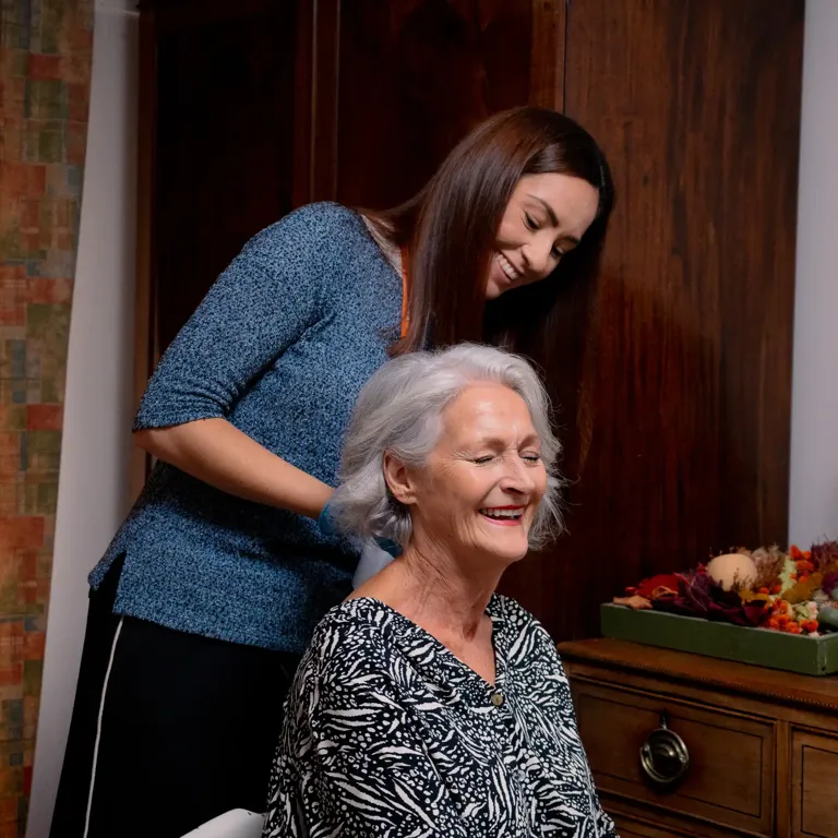 Client having their hair brushed by Carer