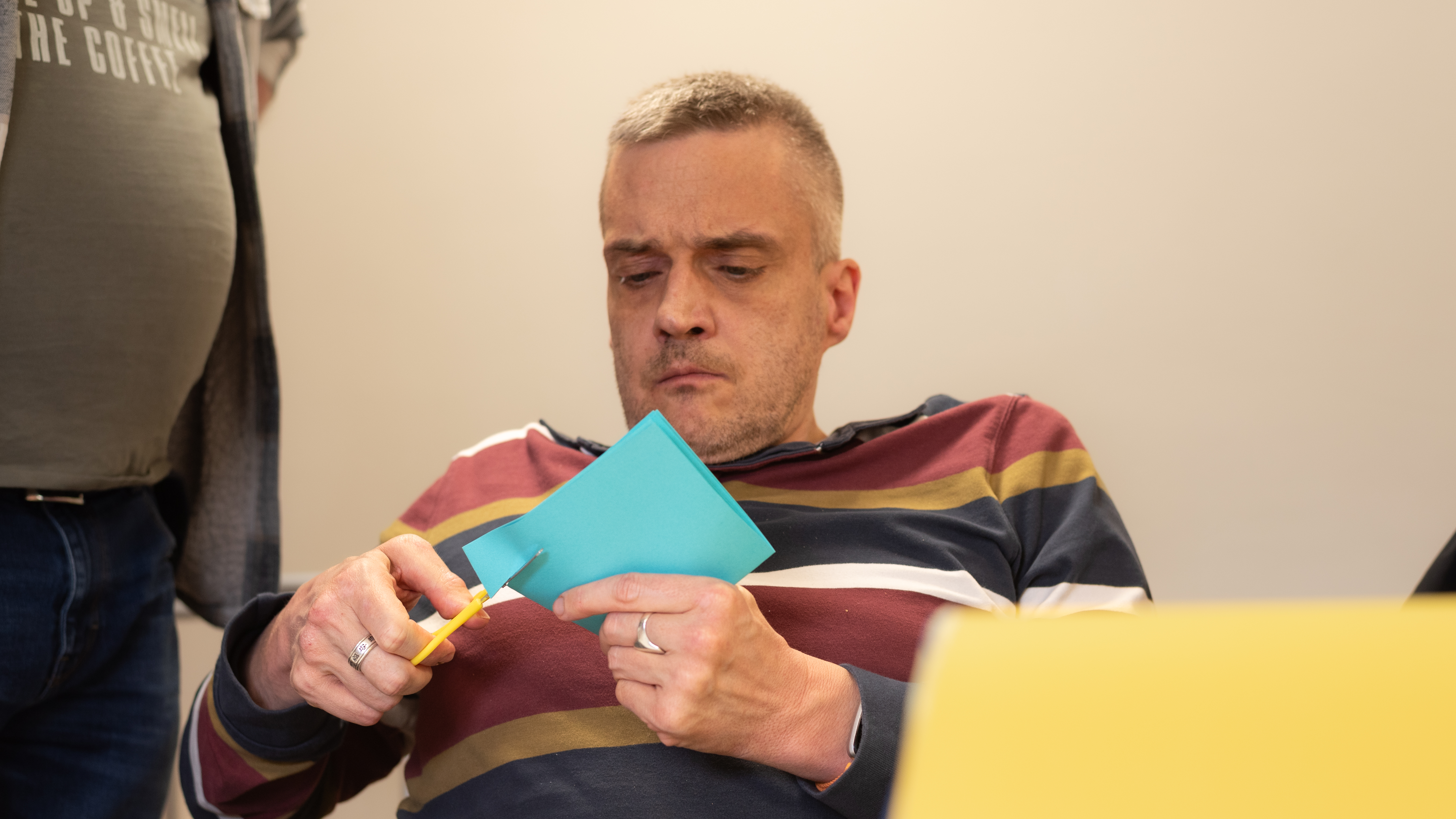 Client cutting paper illustrating neuroplasticity and brain health.