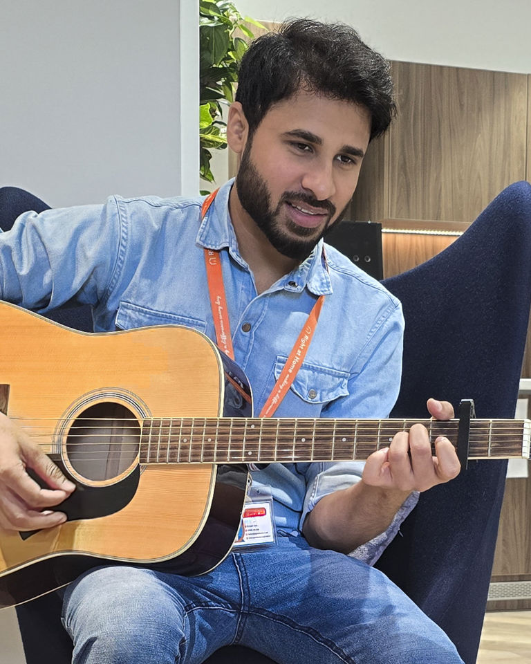 Graham and his Carer, Usman, playing guitar together