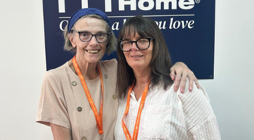 Janice and Angie in front of the new Right at Home logo in the office