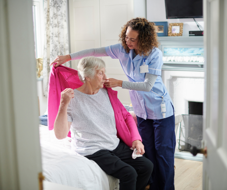 Carer helping elderly lady get dressed