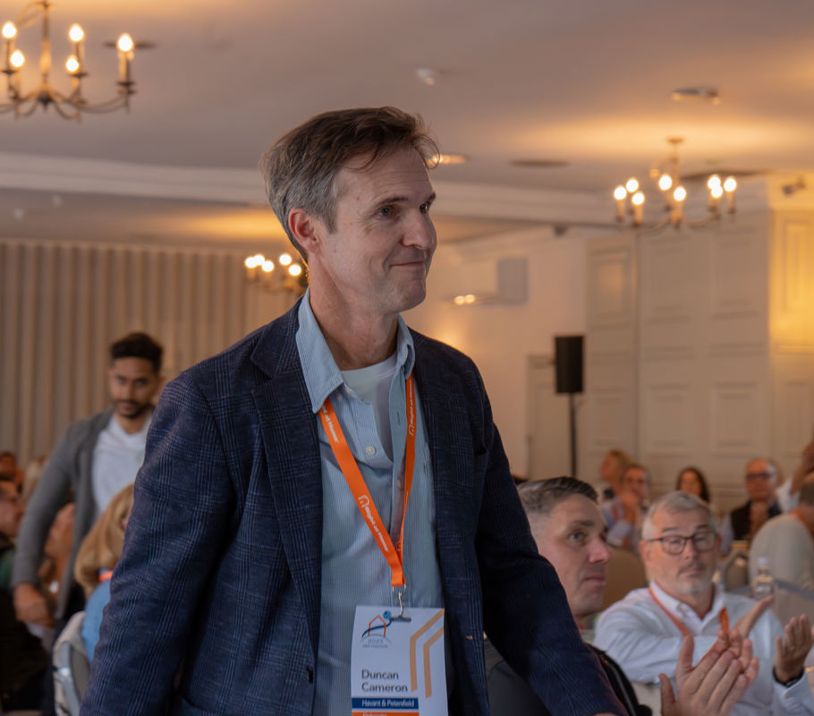 duncan cameron collects award at conference