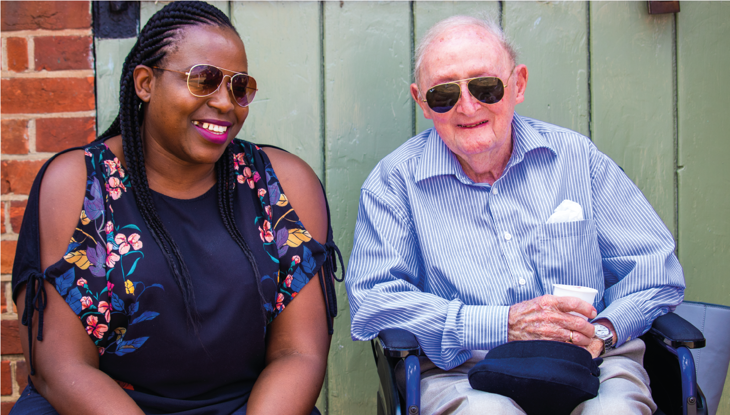 A Carer smiles next to a Client 