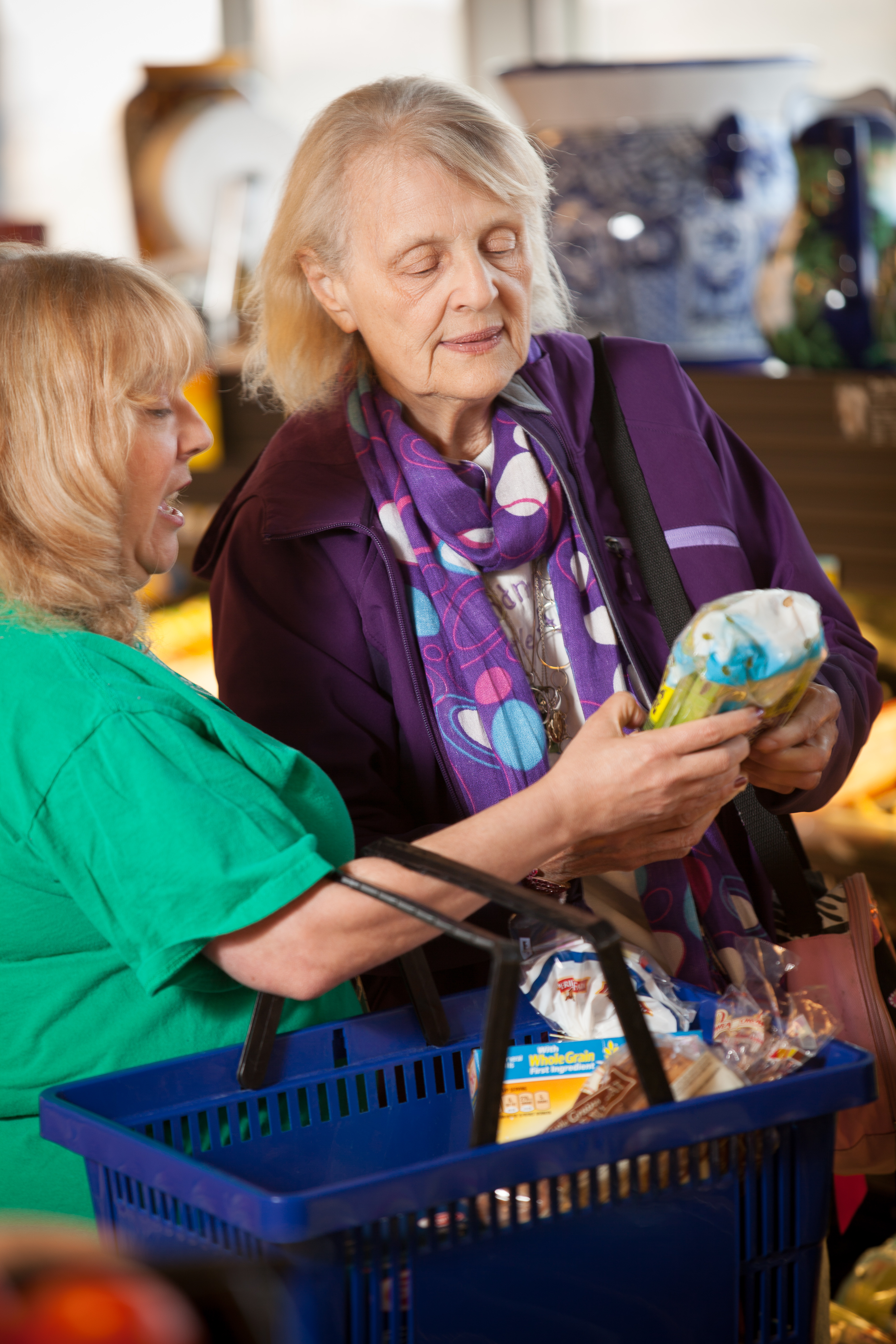 Homecare caregiver in supermarket with client