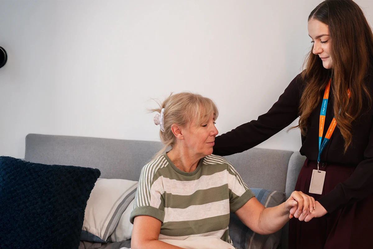 Client living with cancer supported to get in to bed safely 