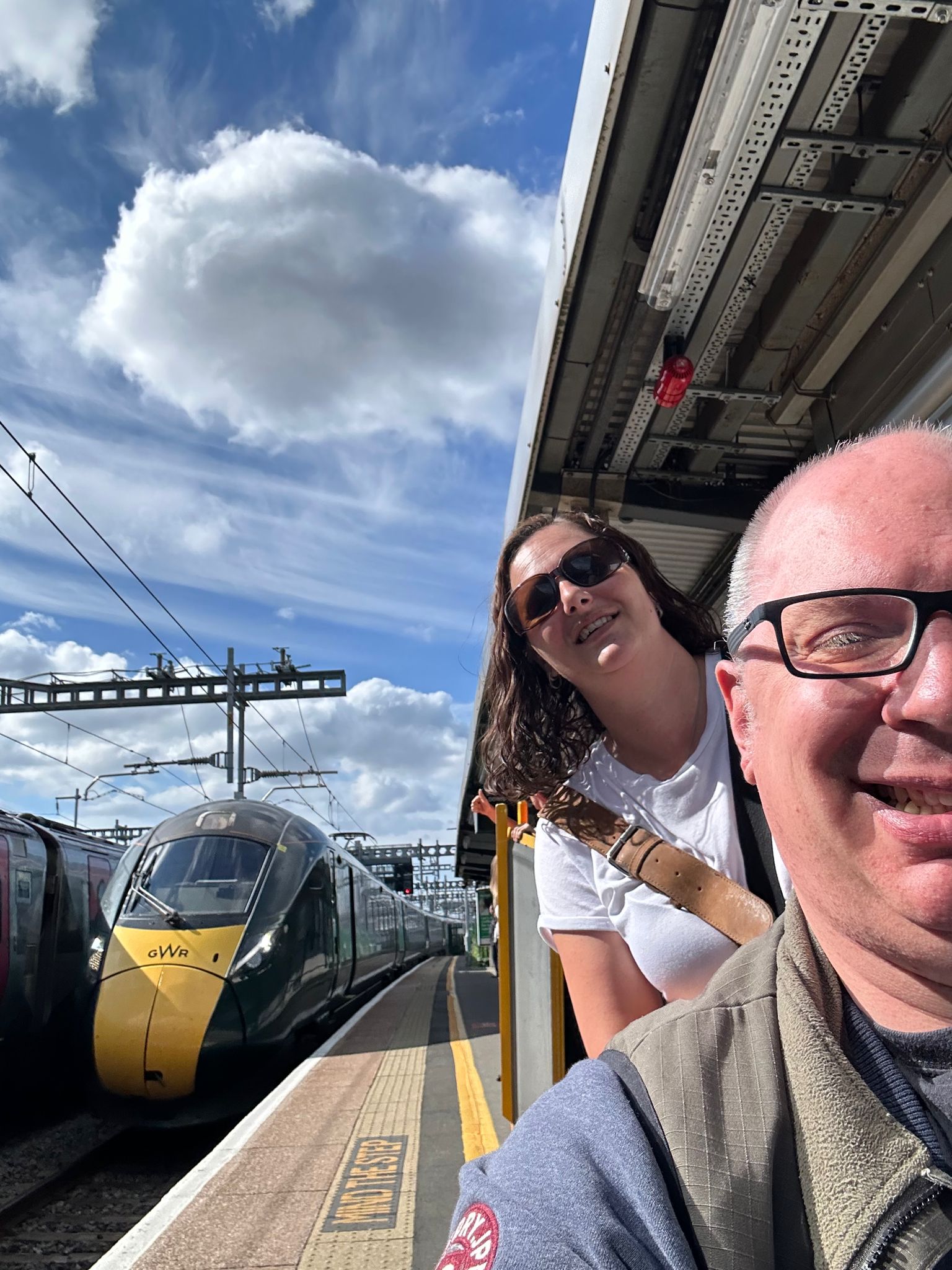 Carer and client stood next to a train, going on a business trip