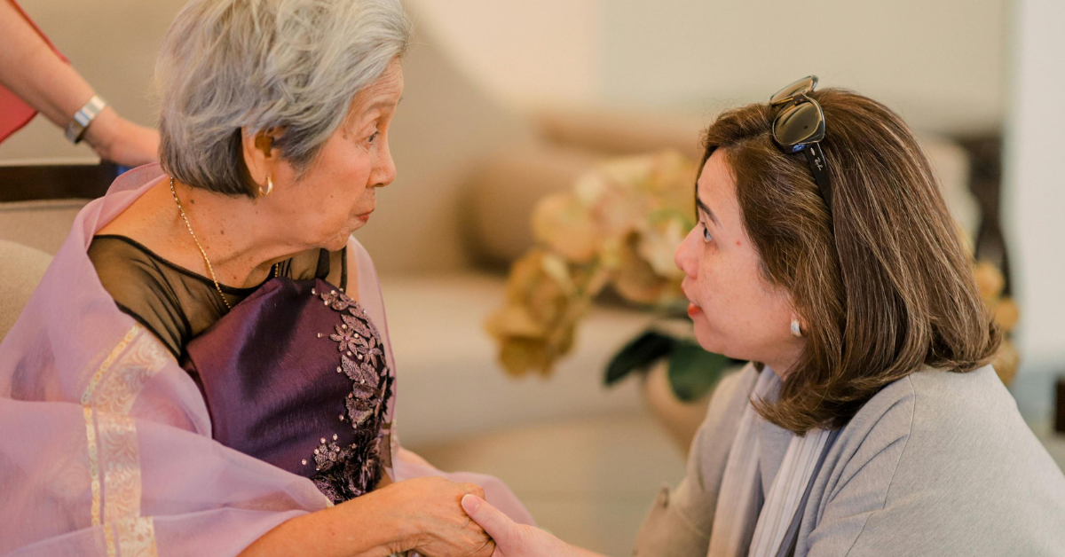 Older woman talking with her daughter at home
