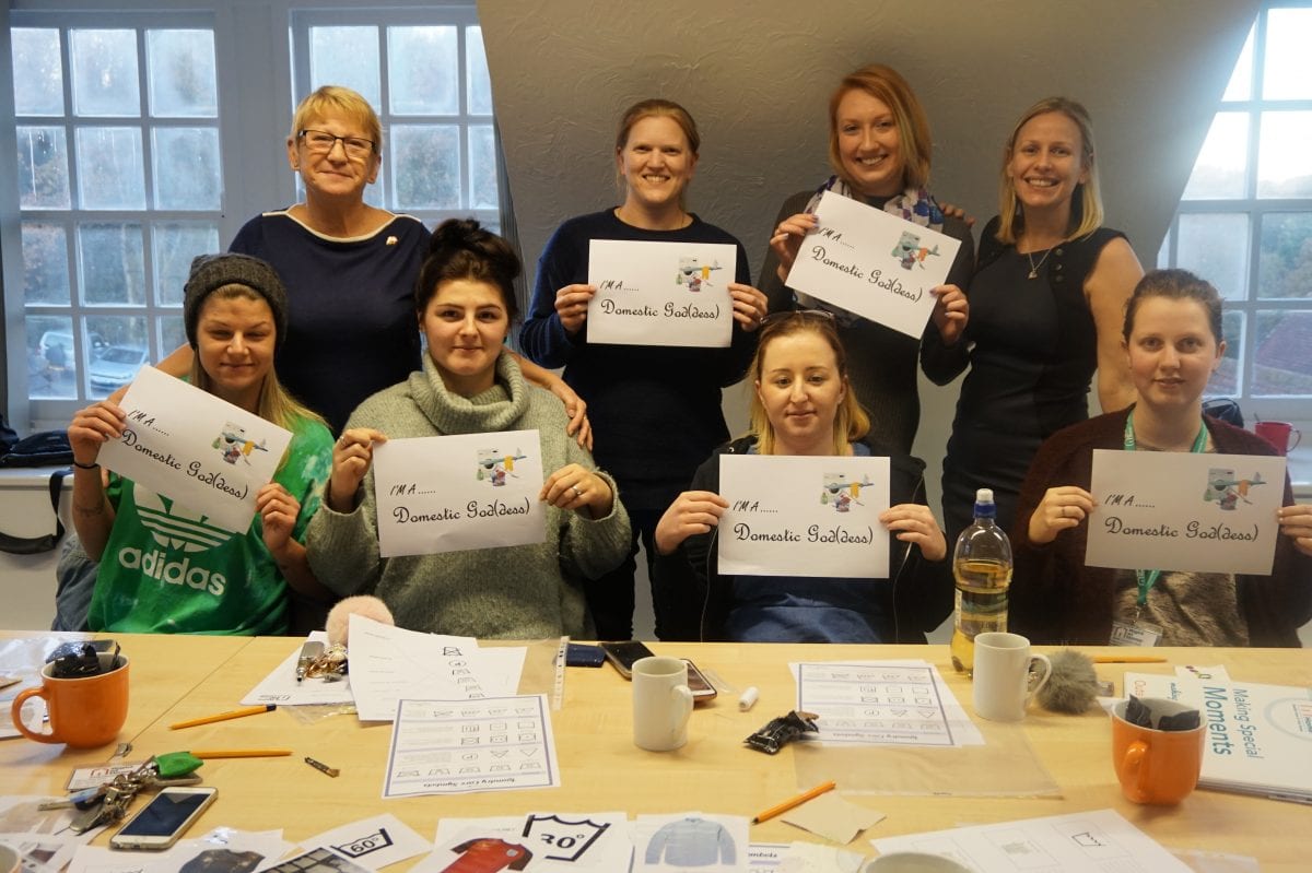 Right at Home Solent Care Assistants Holding up 'Domestic Goddess' Sign