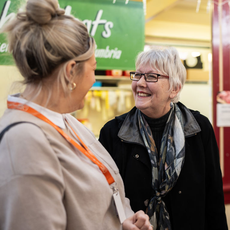 Client and Carer sharing a laugh during a visit to the local market