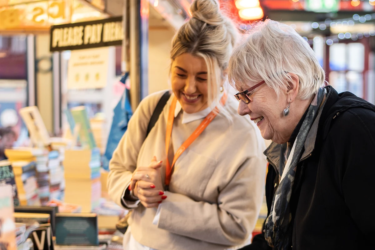 Client and Carer browsing a local market for new books to read 