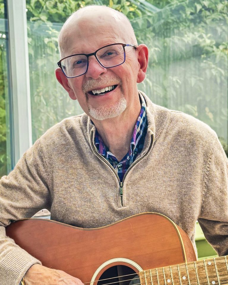 Graham playing his guitar 