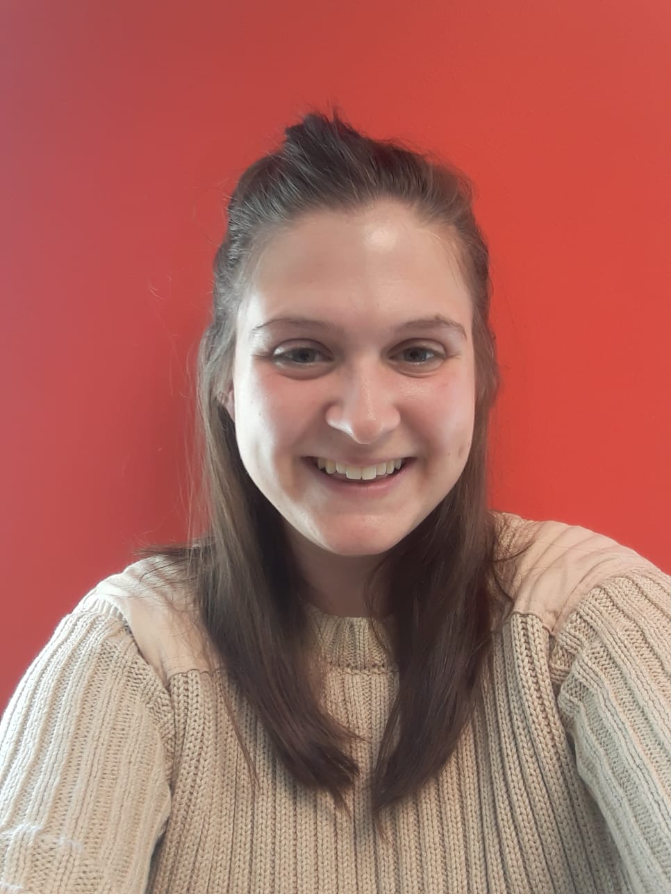 Picture of girl smiling with orange background