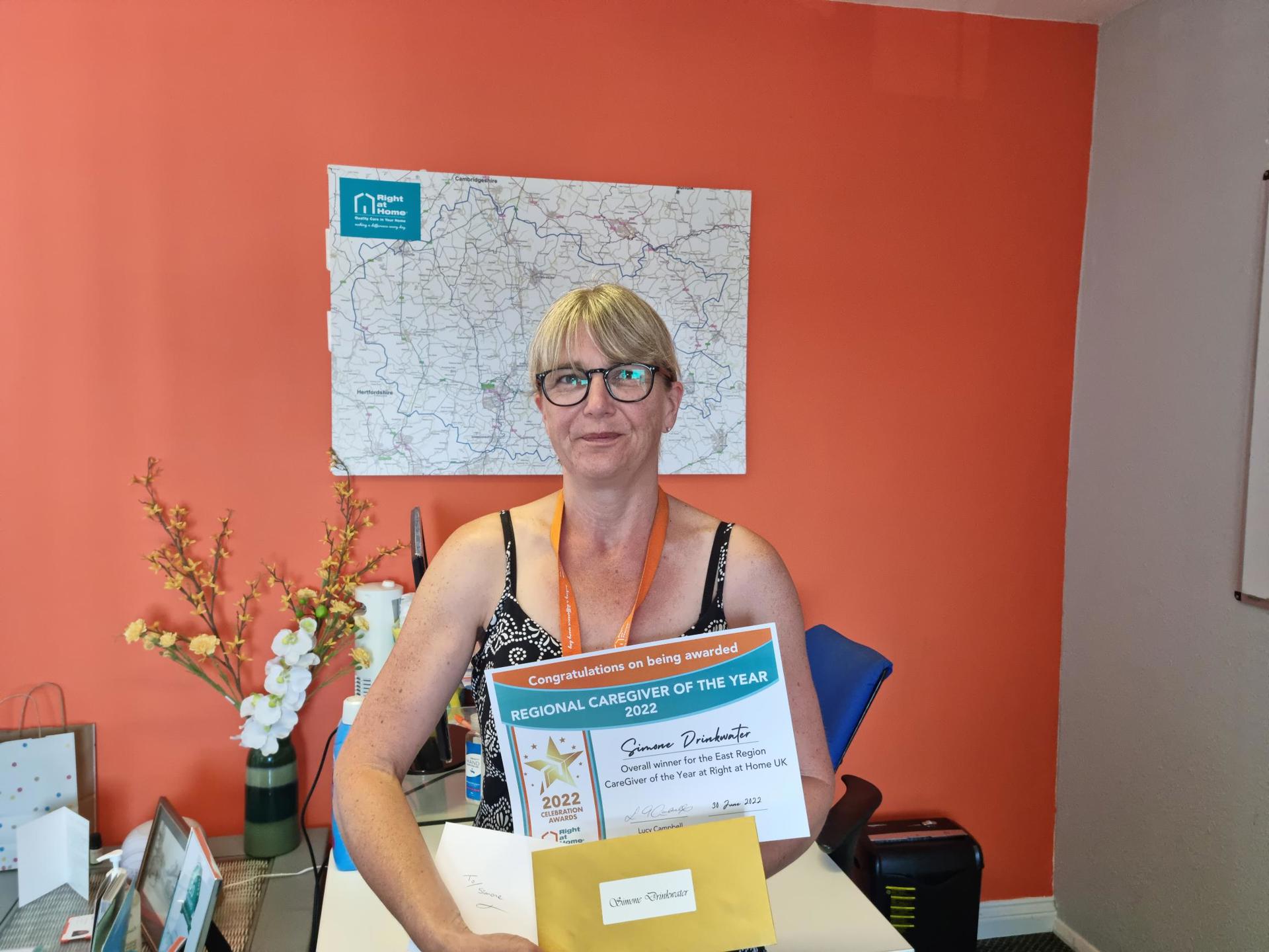 Regional CareGiver for East Region Simone collecting her award