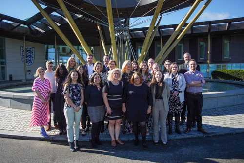 Team picture of Right at Home National Office team stood outside Hilton Hotel