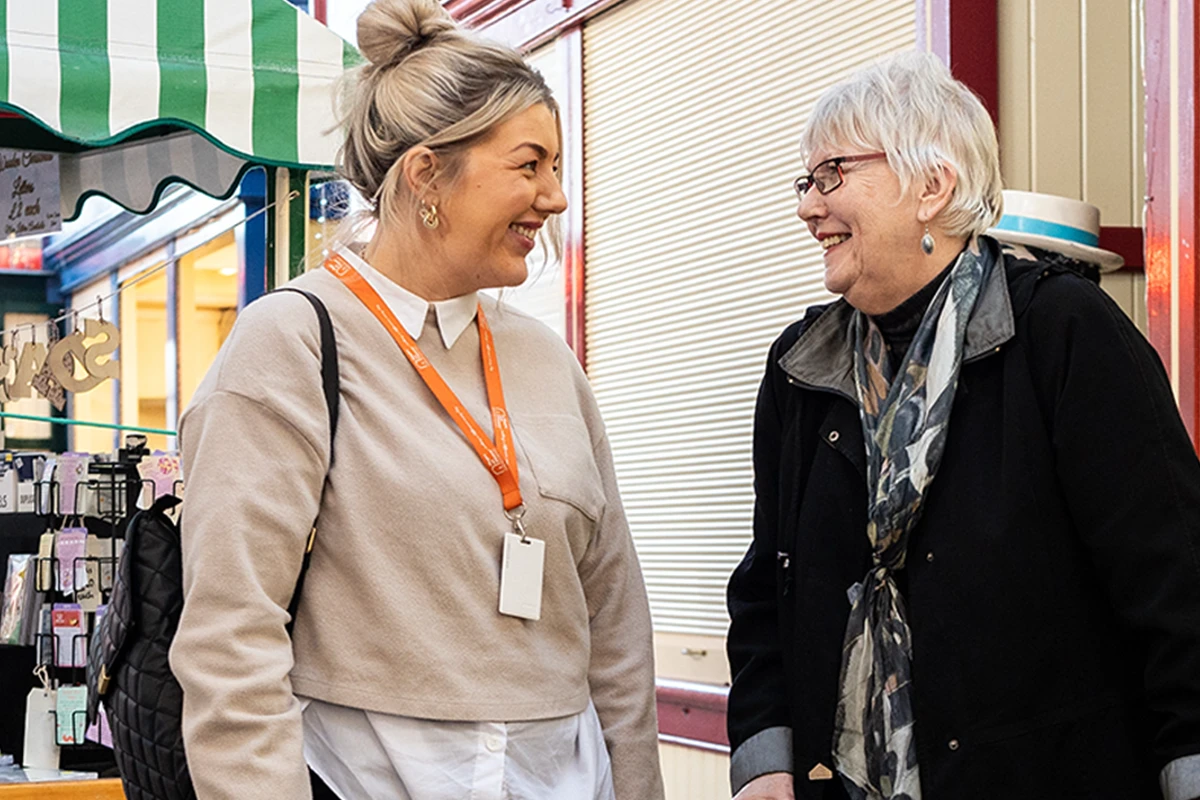 Our Client enjoying a day out at a local market with support from their Carer