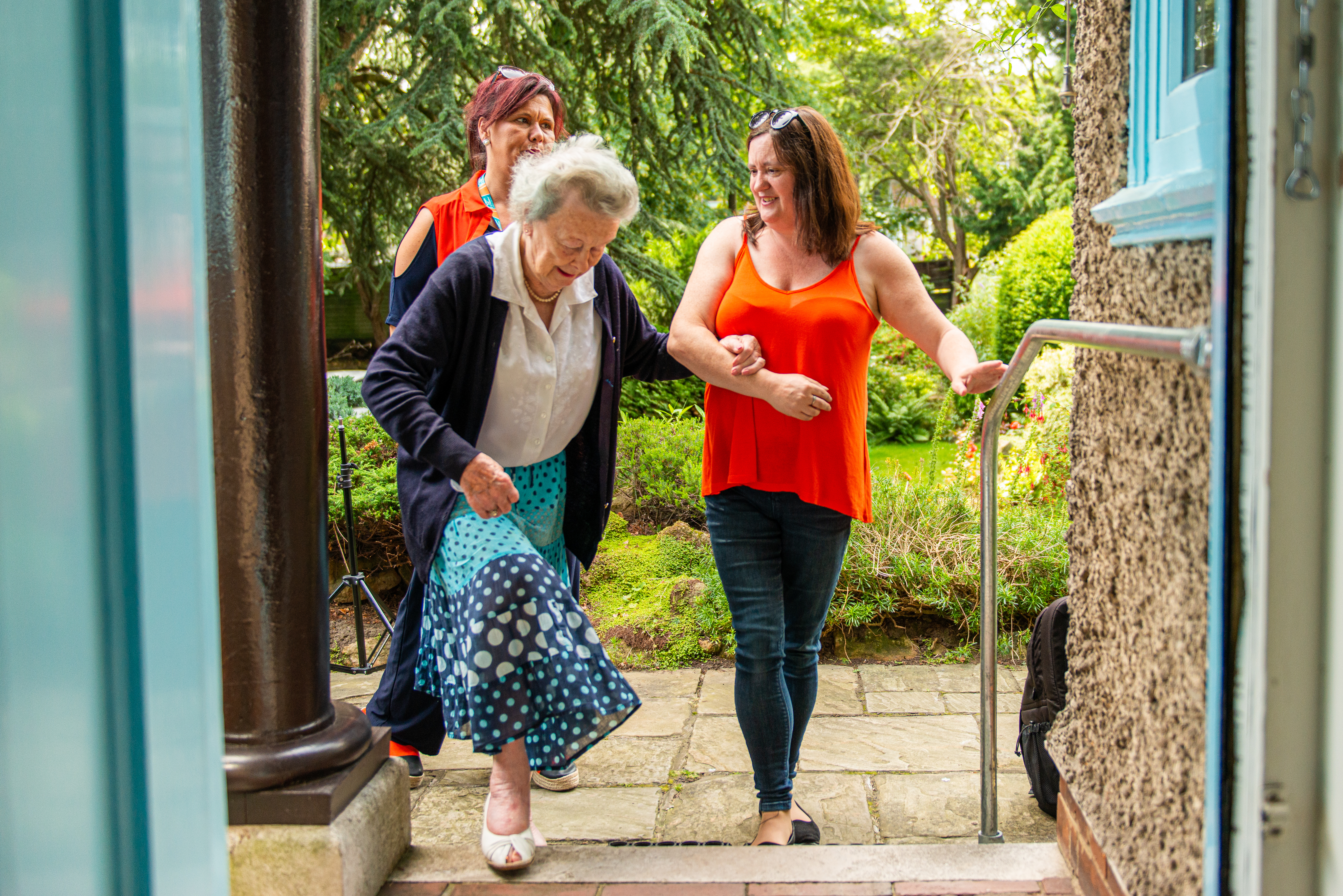 Carer and Client walking together linked arms