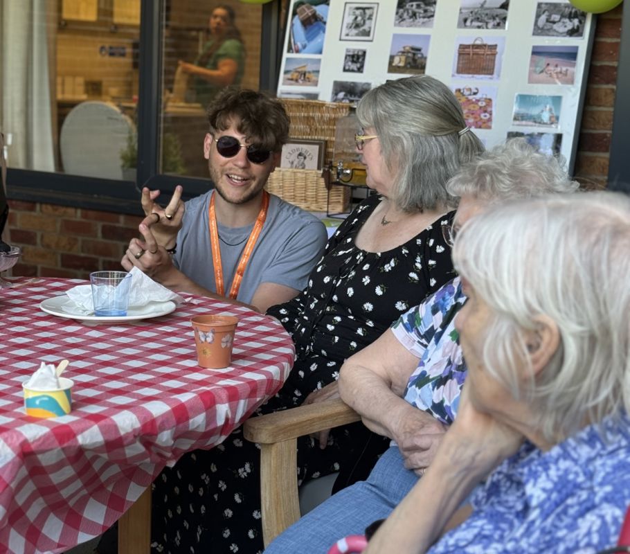 Right at Home caregiver chatting with clients at the Big Green Picnic community event.
