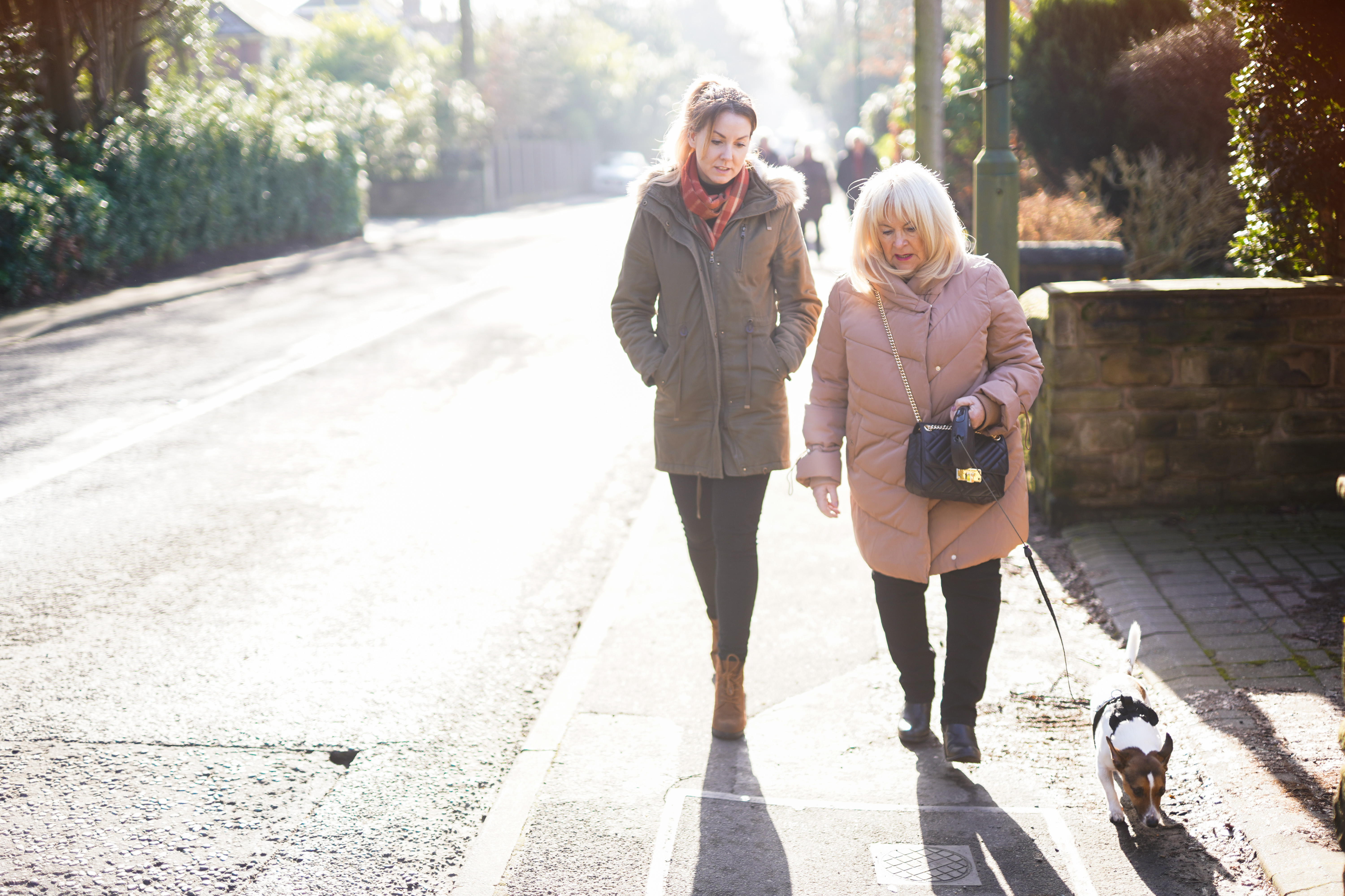 Caregiver walking with client down the road