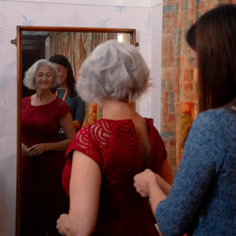 Carer supporting Client to get ready for an evening out with friends