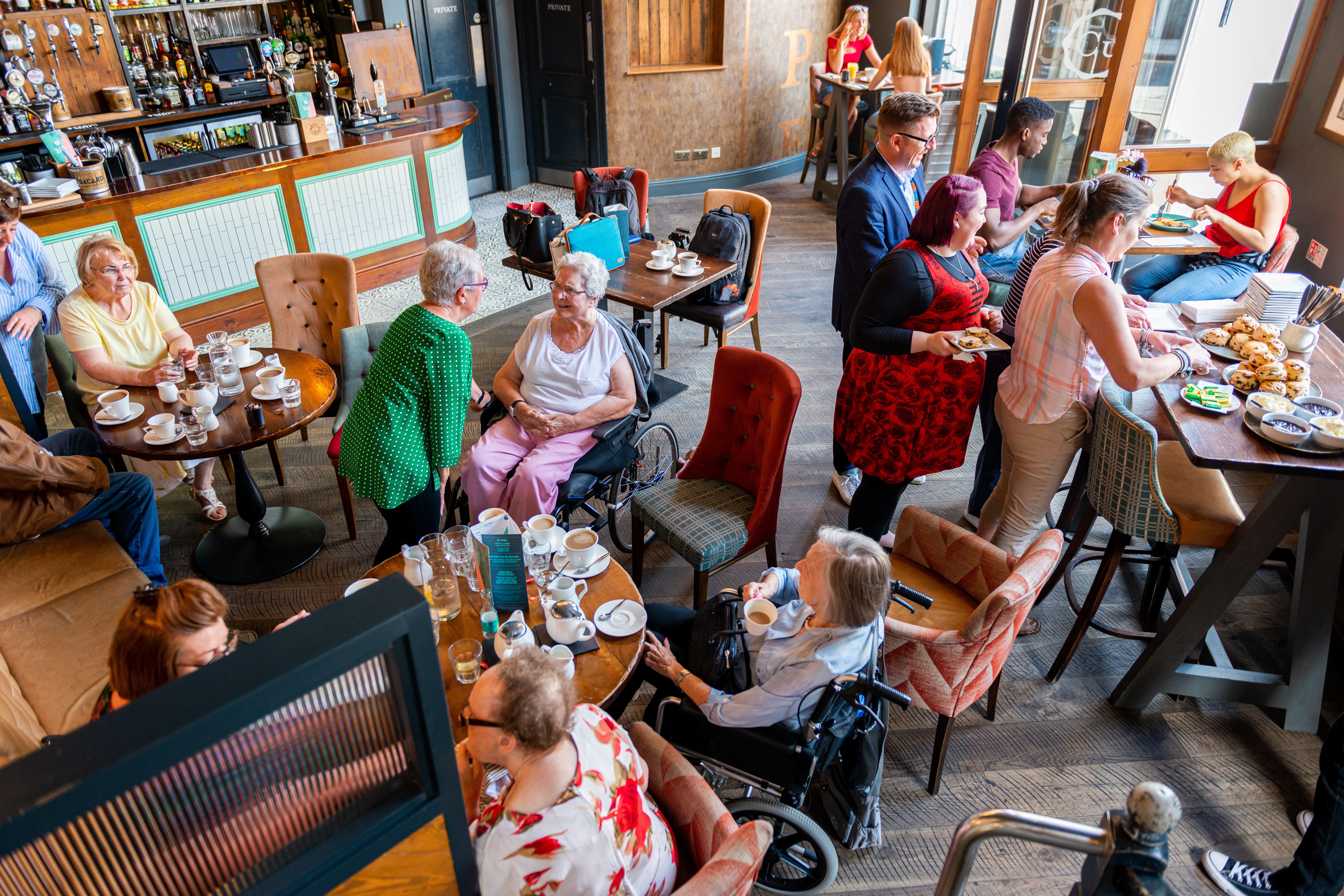 Friends and families gathered at a restaurant, sharing laughter and delicious food together.