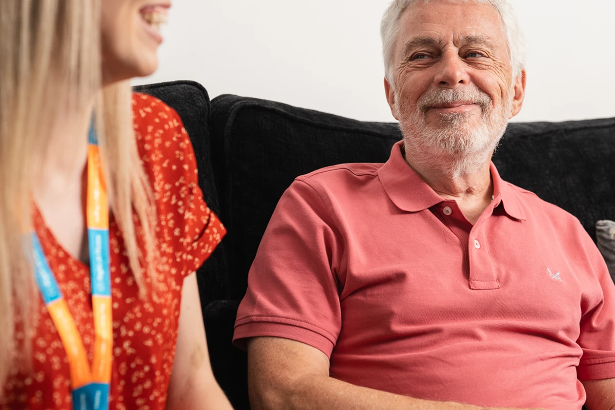 Client and Carer discussing old memories in the comfort of home