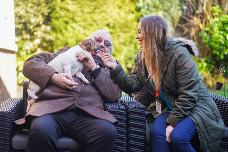 CareGiver with male client and pet dog 