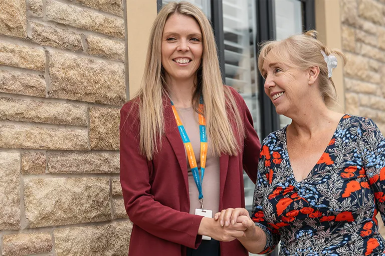 Client and Carer enjoying a walk around the garden
