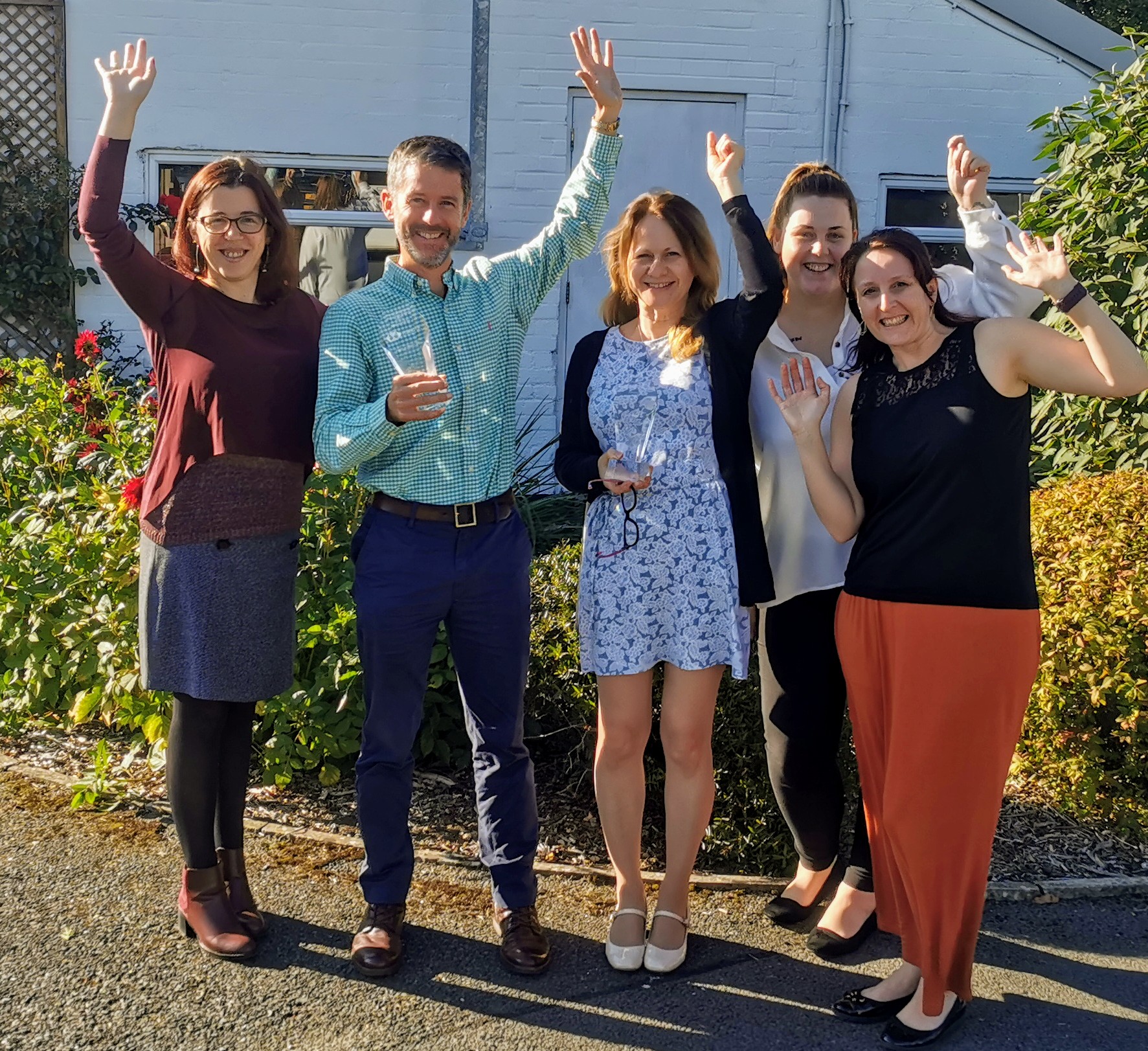 Group of people celebrating and looking happy.
