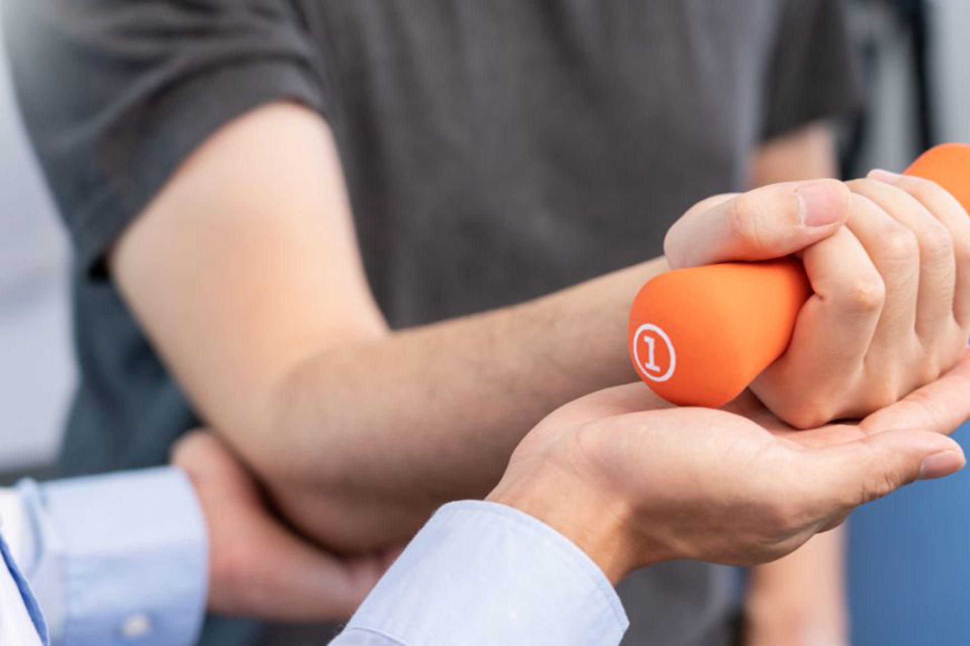 caregiver-helping-a-client-at-home-with-stroke-rehabilitation-through-the-use-of-weights