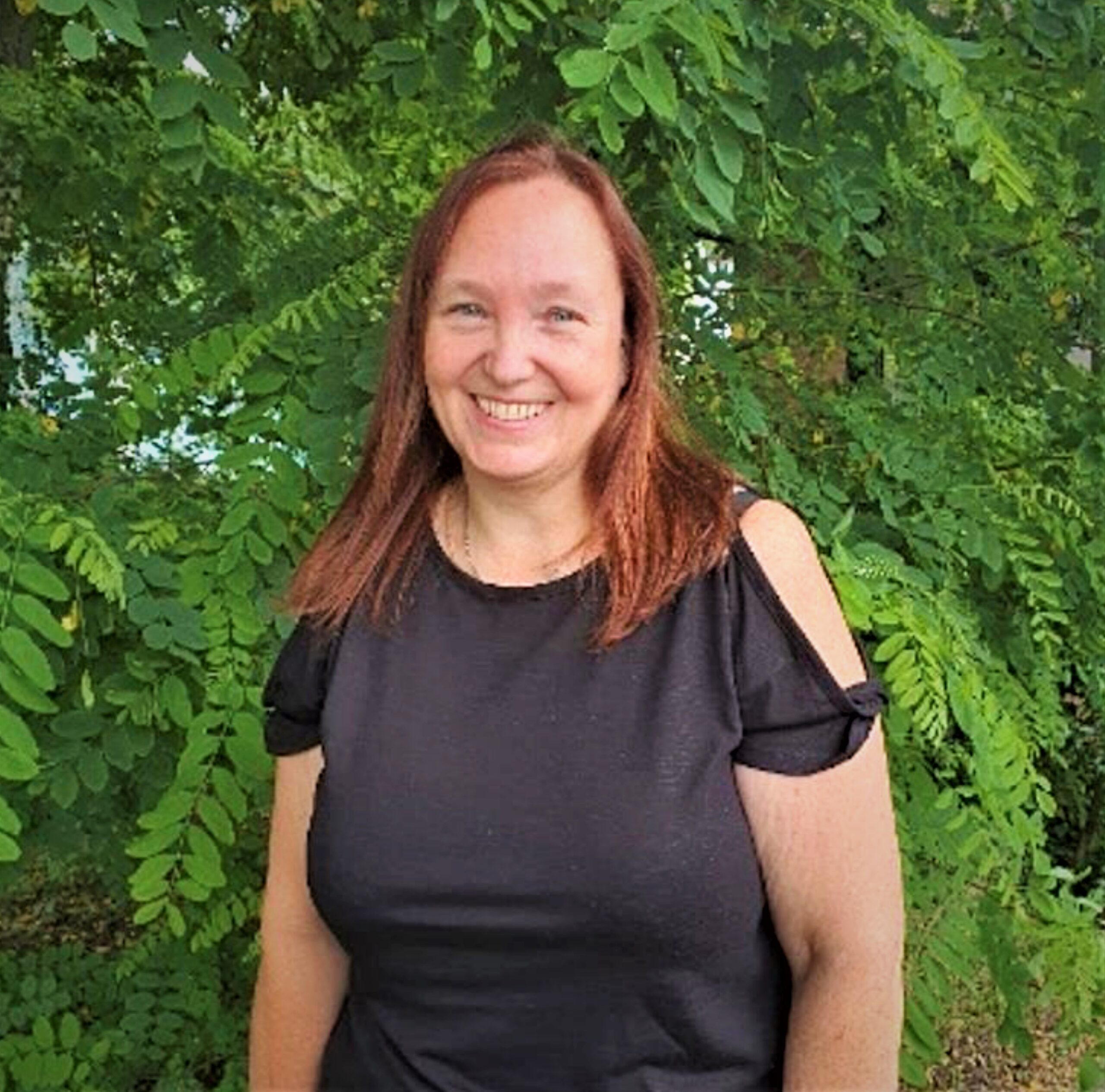 A Care Assistant from Right at Home Solent Smiling Outside