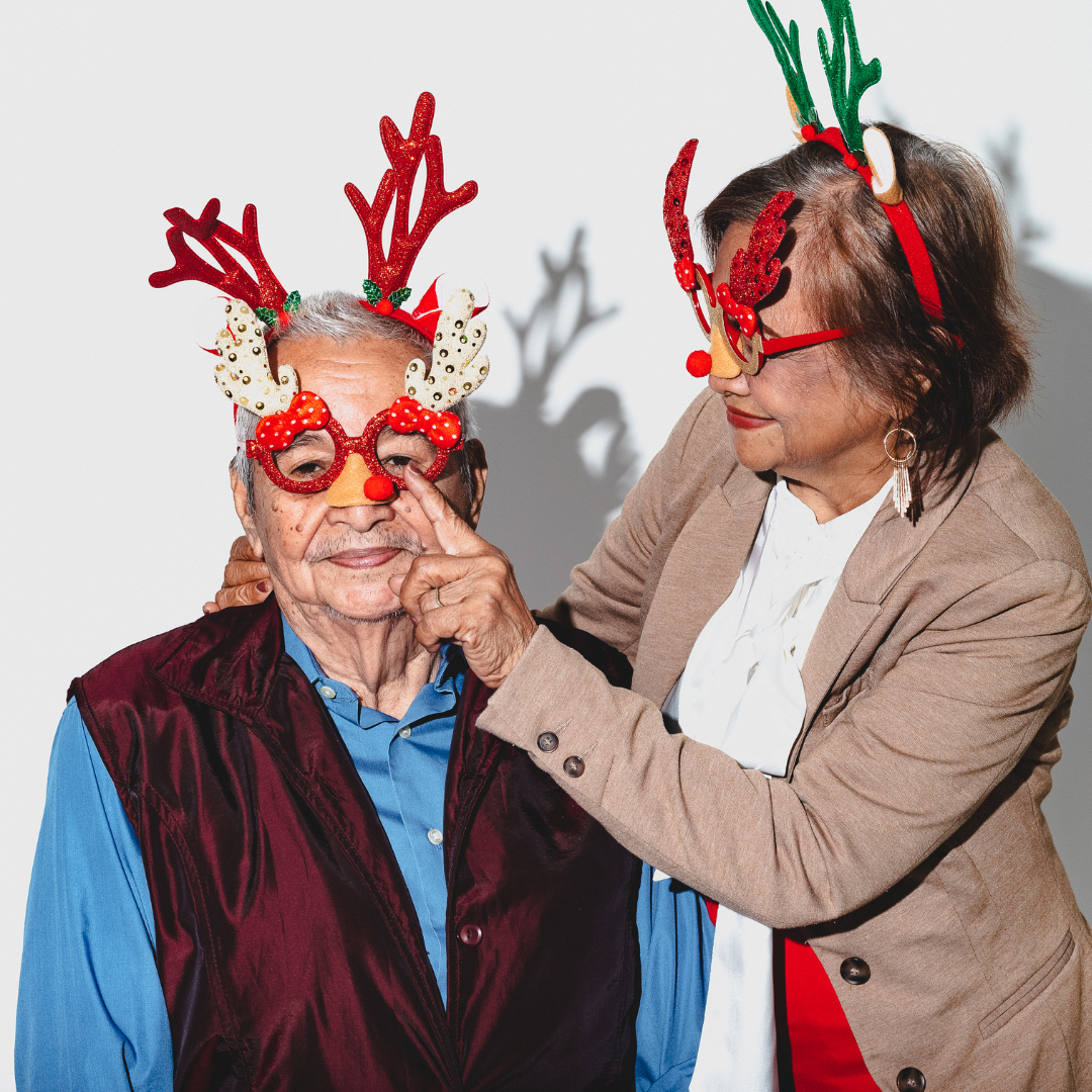 Elderly couple with Christmas glasses